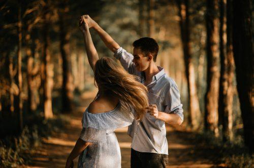man and woman dancing at center of trees