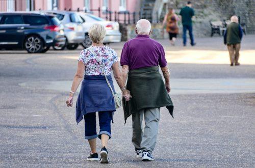 man and woman walking on the street during daytime