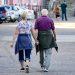 man and woman walking on the street during daytime