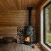 A wood burning stove inside of a wooden cabin